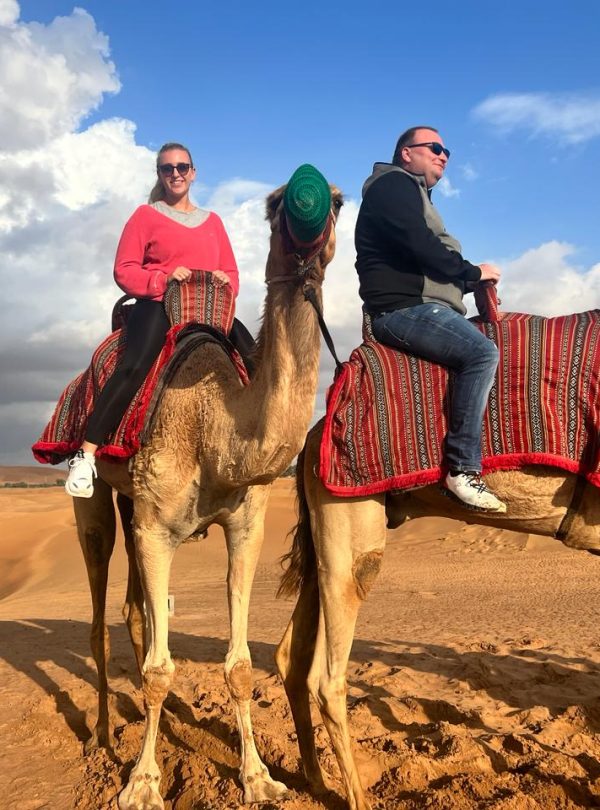 camel riding in desert
